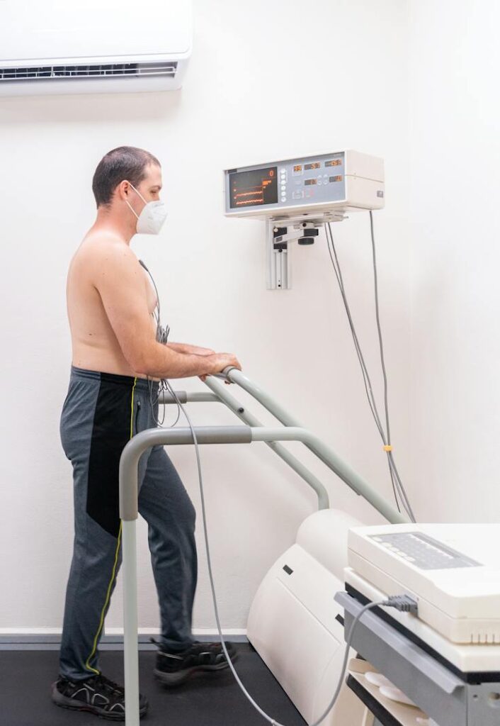 Patient undergoing a cardiac stress test in a medical clinic with a healthcare team.